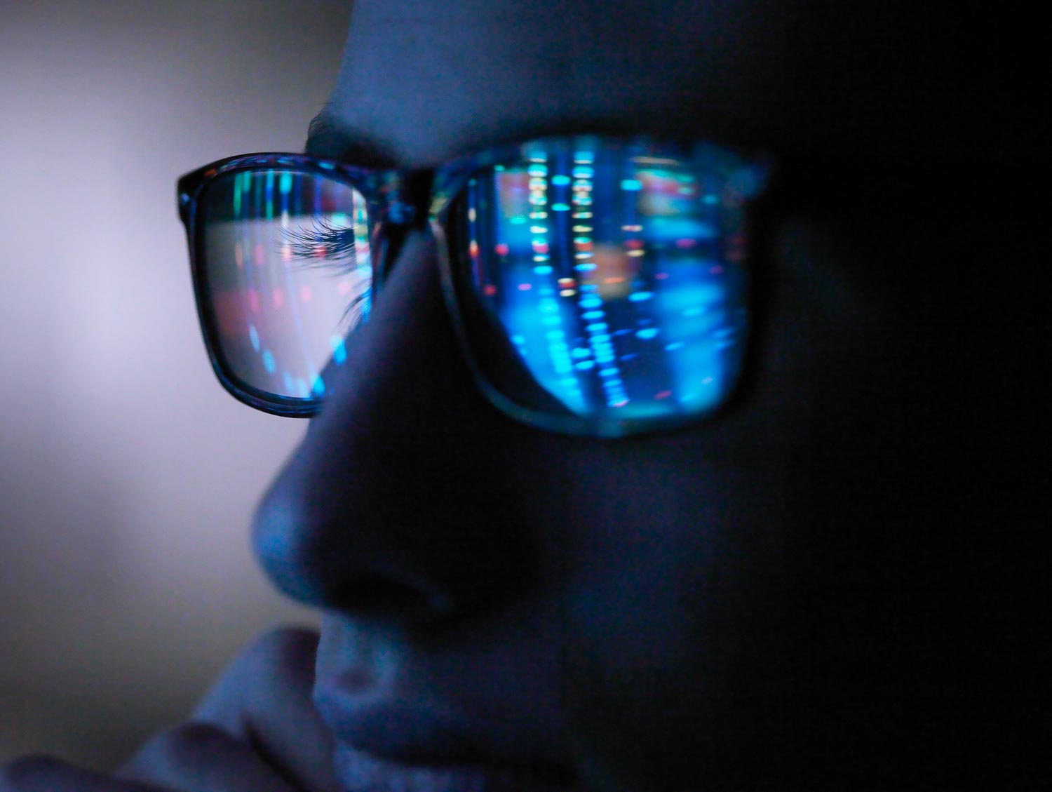 Genetic research, computer screen reflection in spectacles of DN